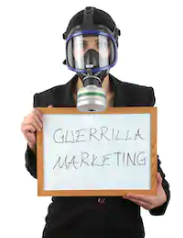 Man holding Introduction to guerilla marketing sign